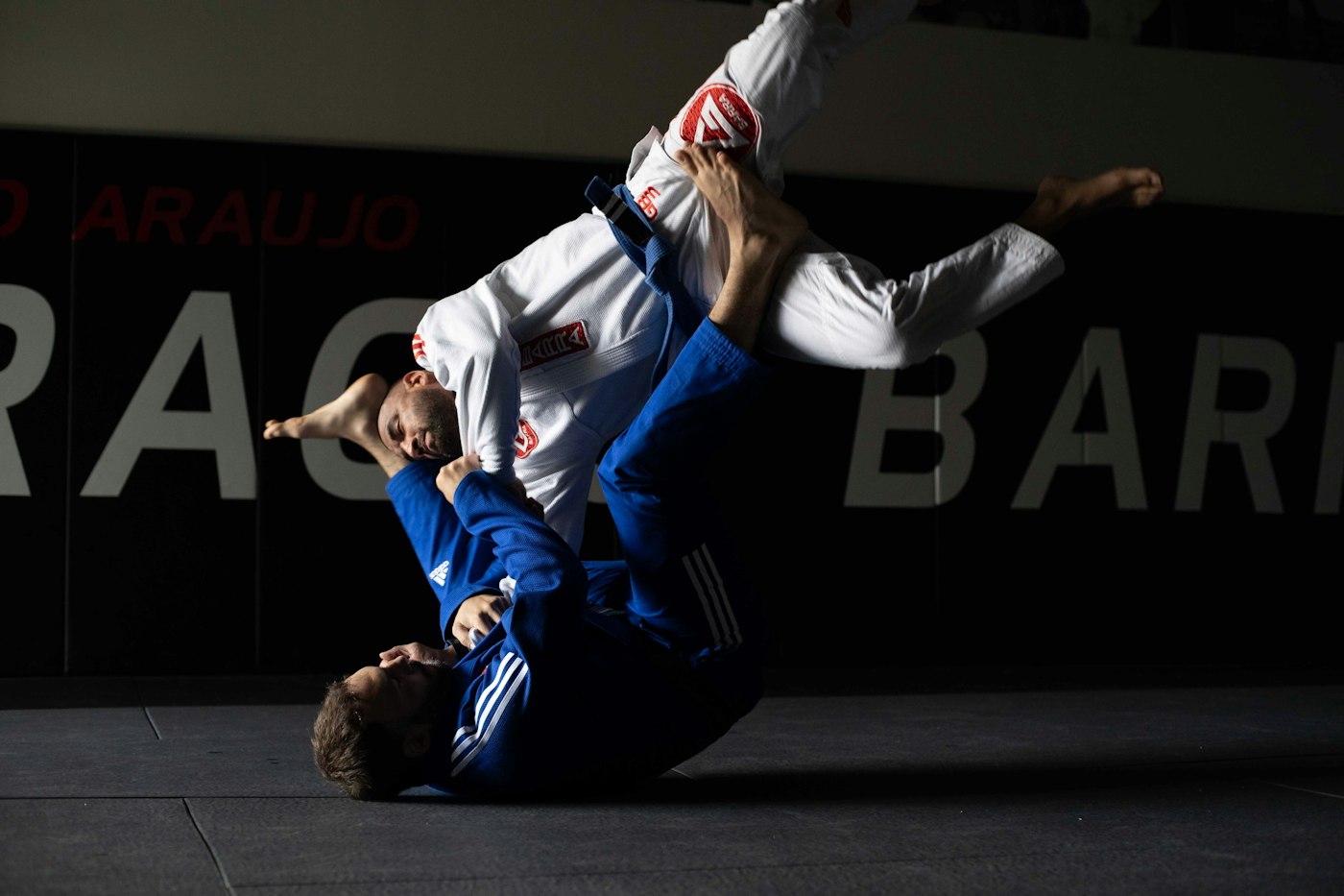 Judoka throwing an opponent through the air during a match