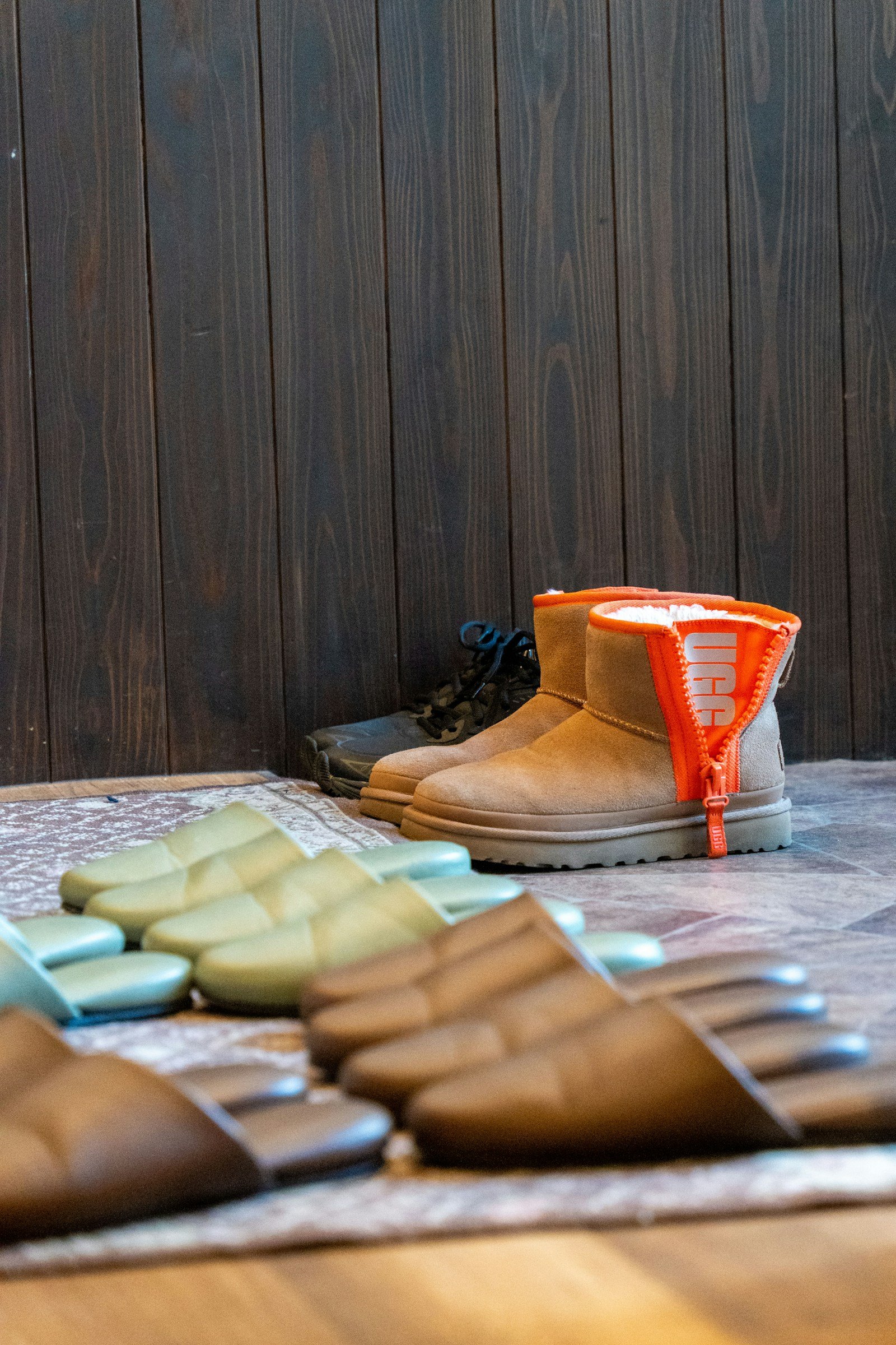 Leather boots and shoes lined up in rows on a market table